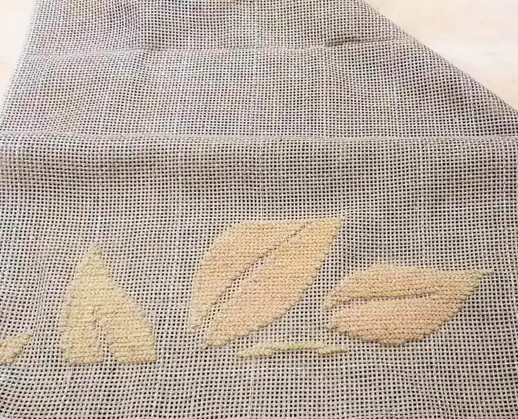 Close-up of Arraiolo wool rug embroidery, showing artisan craftsmanship and eco-friendly materials