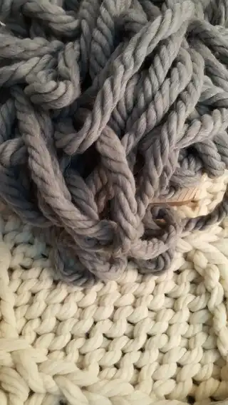 Collection of handmade knit blankets showing pattern evolution