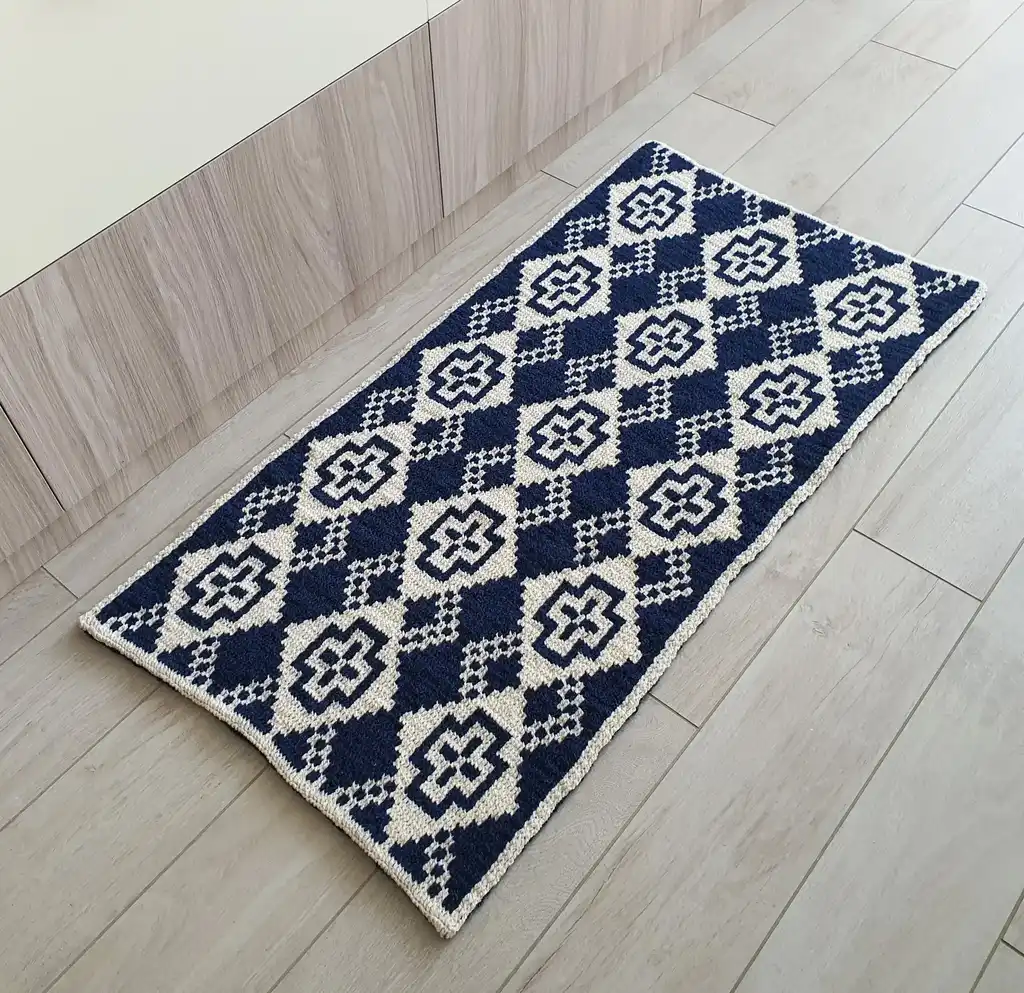 Crochet wool rug in natural colors, perfect for home decor.