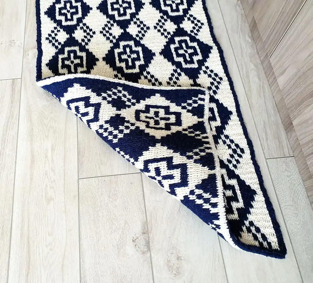 Crochet wool rug in natural colors, perfect for home decor.