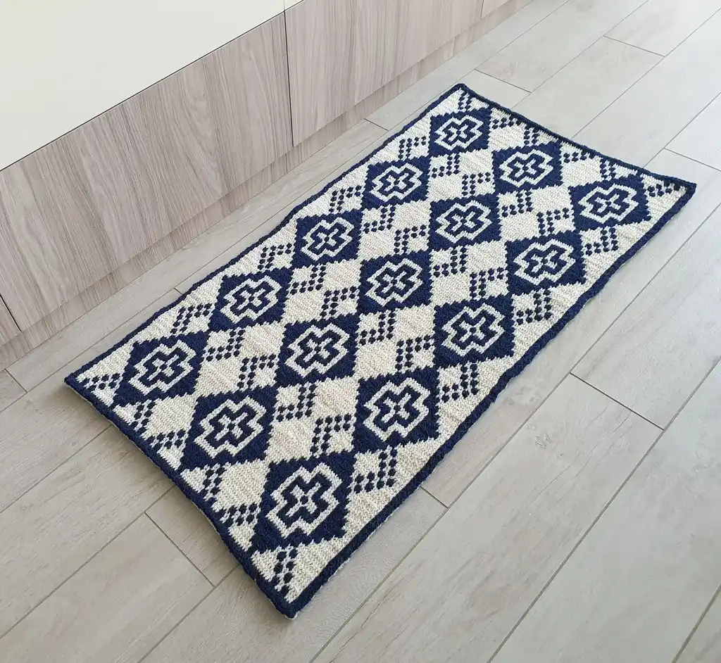Crochet wool rug in natural colors, perfect for home decor.