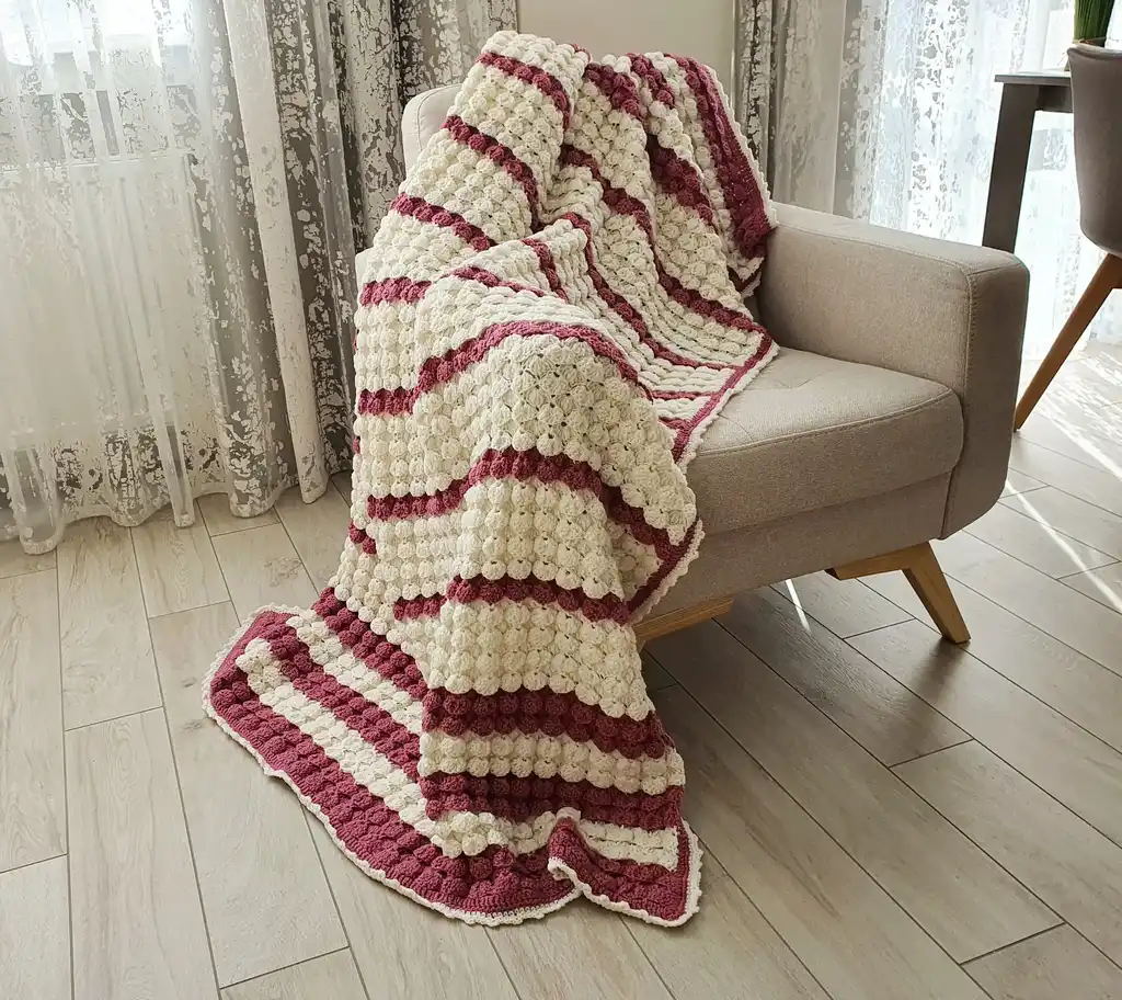 handcrafted crochet throw blanket in blended wool with intricate patterns.