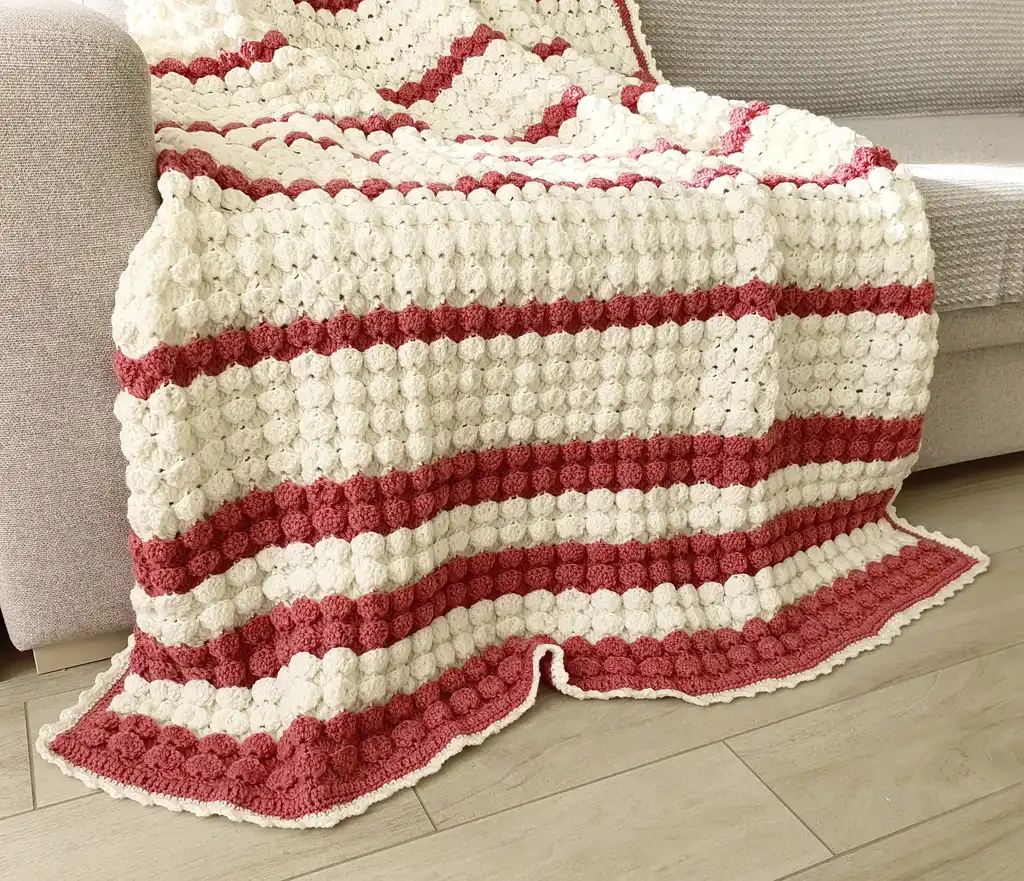 handcrafted crochet throw blanket in blended wool with intricate patterns.