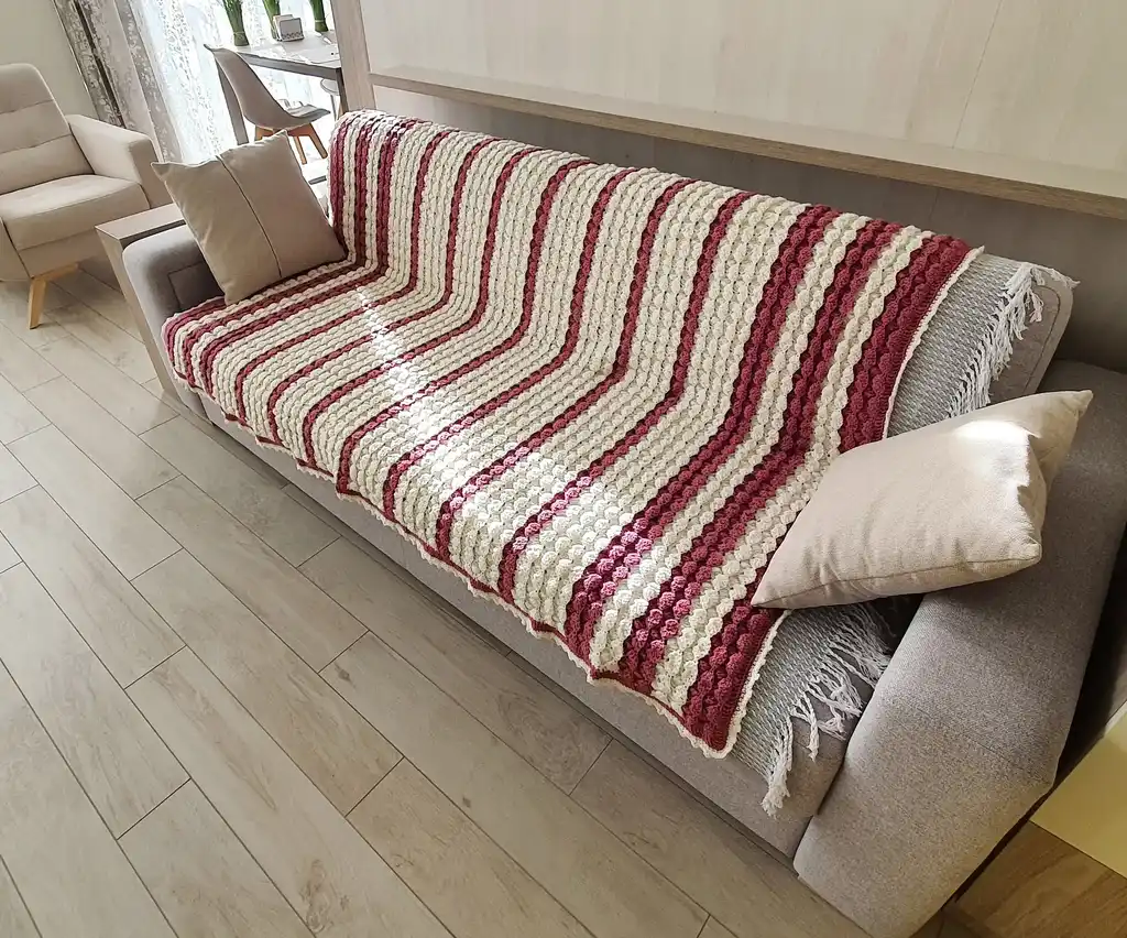handcrafted crochet throw blanket in blended wool with intricate patterns.