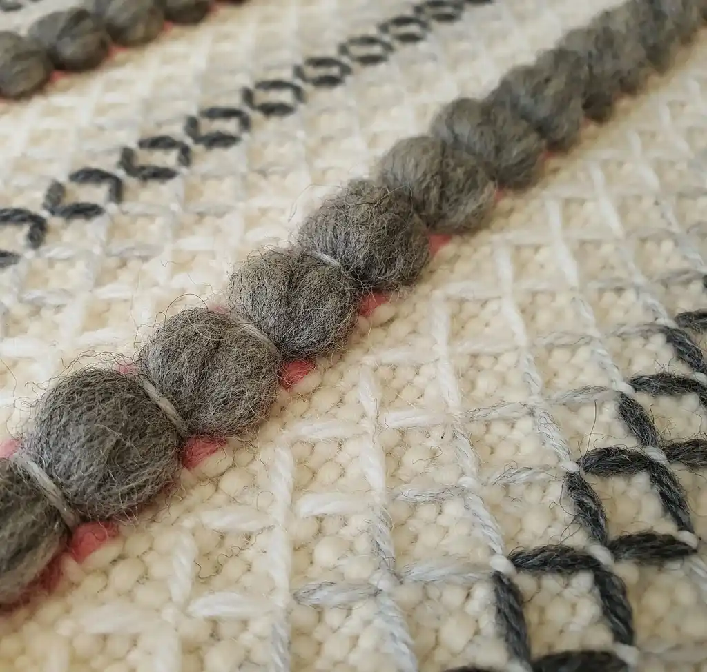 handwoven chunky wool throw blanket in natural color, showcasing traditional weaving texture and premium quality materials.