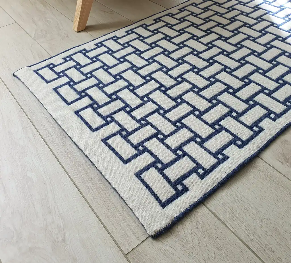 handwoven wool rug in natural colors showing detailed weaving texture and craftsmanship.