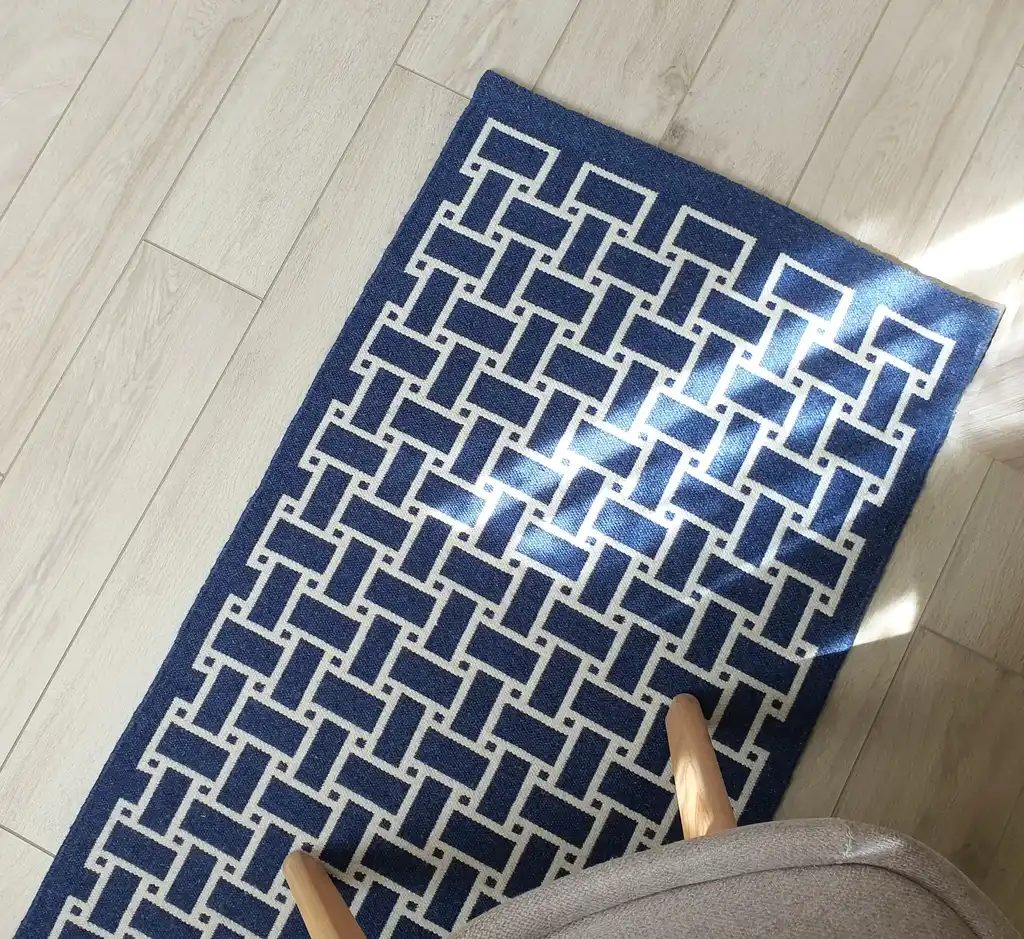 handwoven wool rug in natural colors showing detailed weaving texture and craftsmanship.