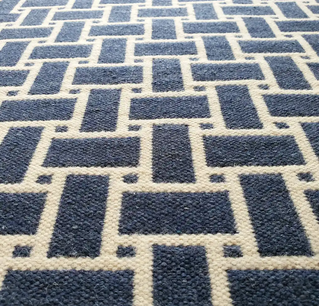 handwoven wool rug in natural colors showing detailed weaving texture and craftsmanship.