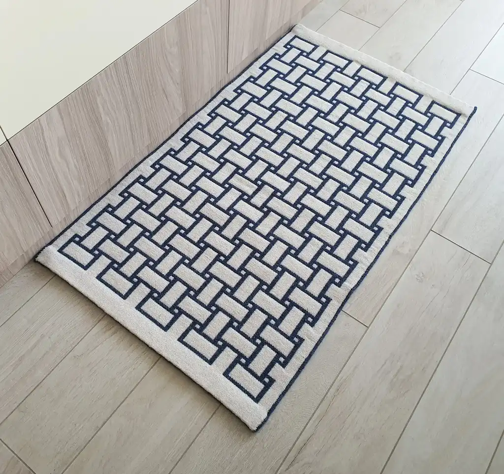 handwoven wool rug in natural colors showing detailed weaving texture and craftsmanship.