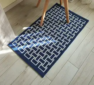 handwoven wool rug in natural colors showing detailed weaving texture and craftsmanship.