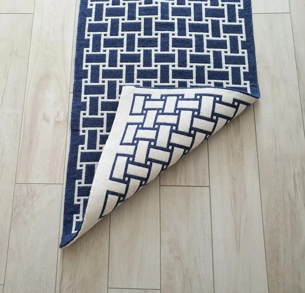 handwoven wool rug in natural colors showing detailed weaving texture and craftsmanship.