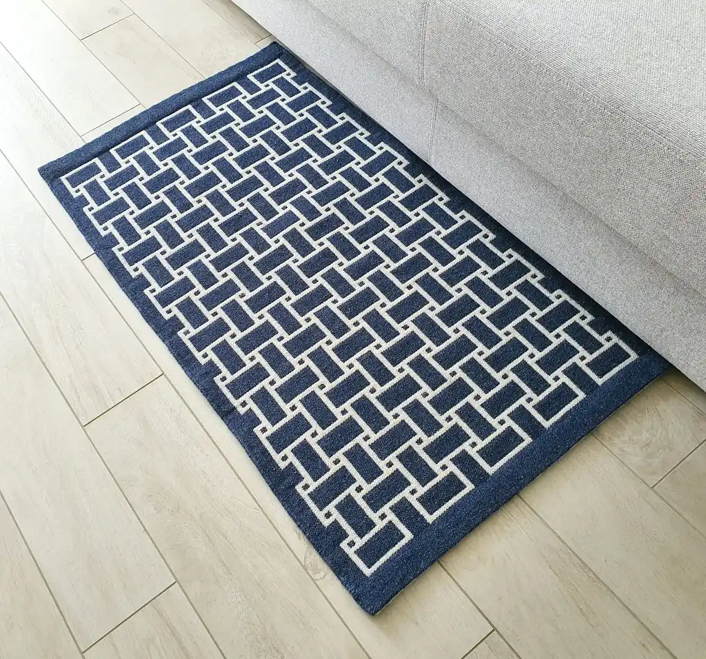 handwoven wool rug in natural colors showing detailed weaving texture and craftsmanship.