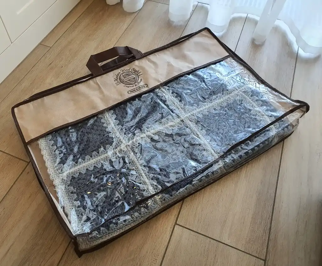Crochet wool throw blanket in natural tones.