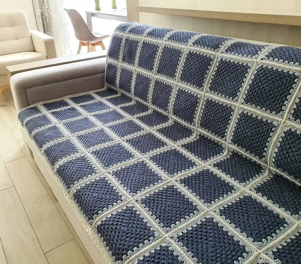 Crochet wool throw blanket in natural tones.