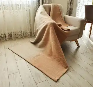 handwoven merino wool throw blanket in natural texture, luxury home textile.