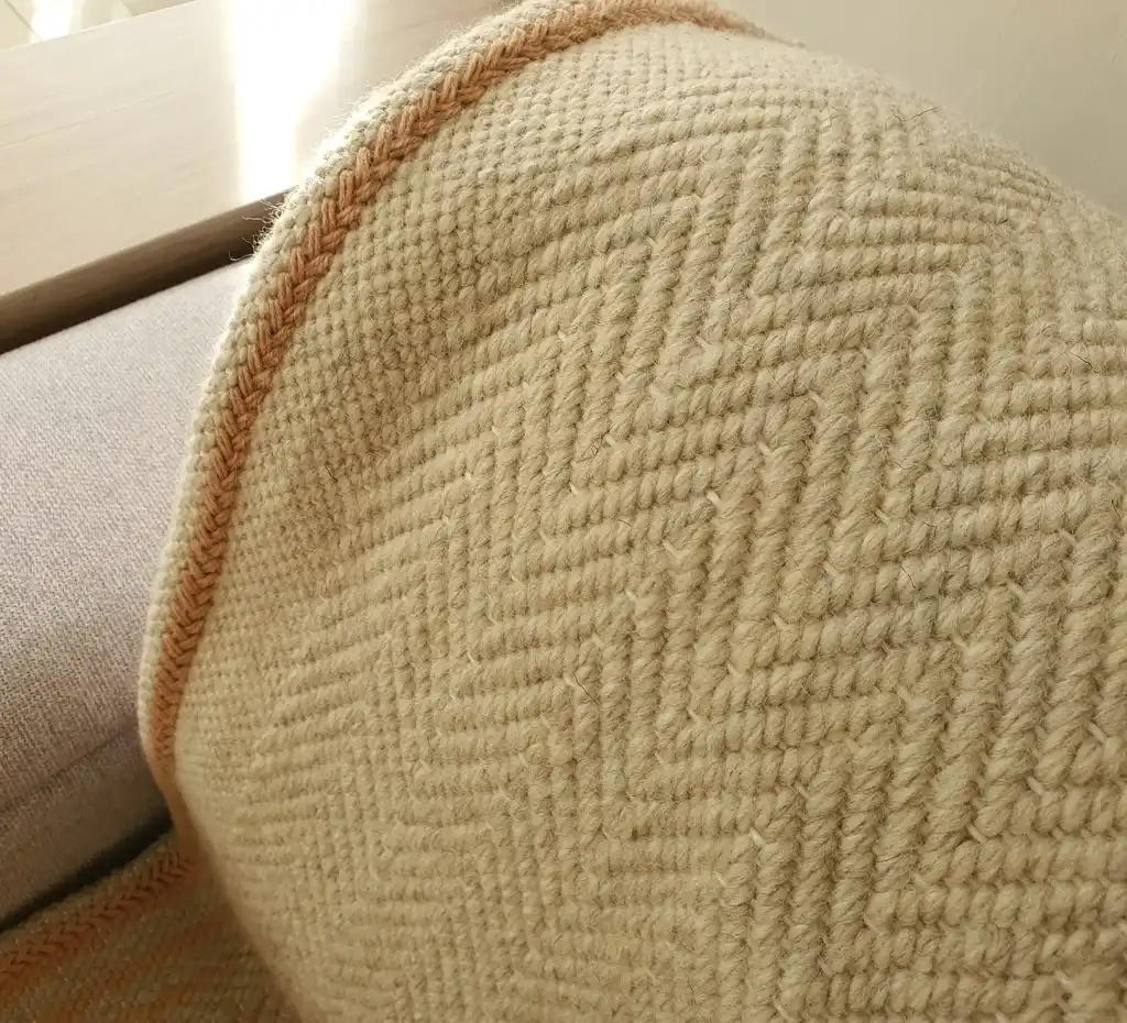 handwoven merino wool throw blanket in natural texture, luxury home textile.