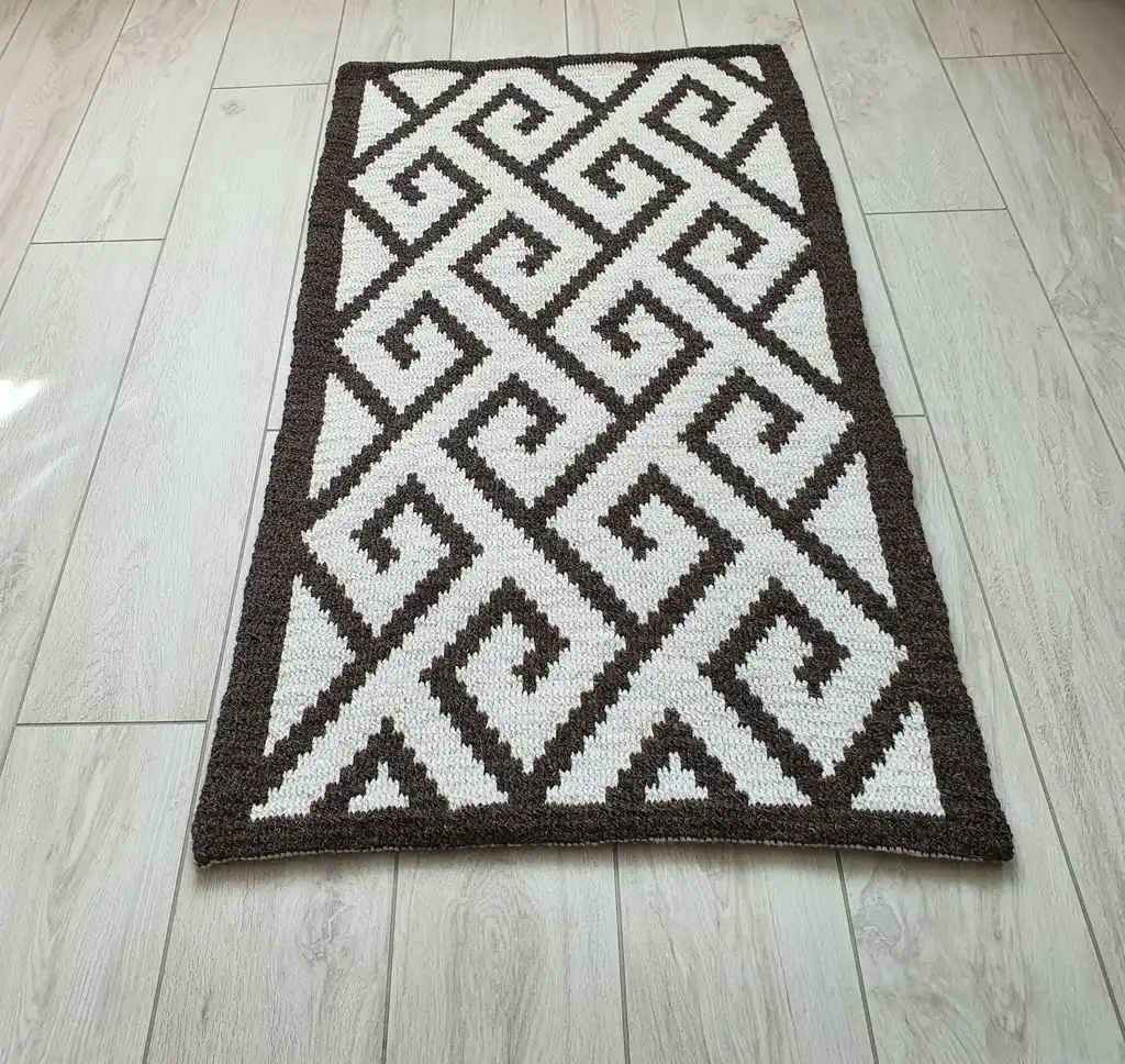 Crochet wool rug in natural colors, showing detailed texture and craftsmanship.
