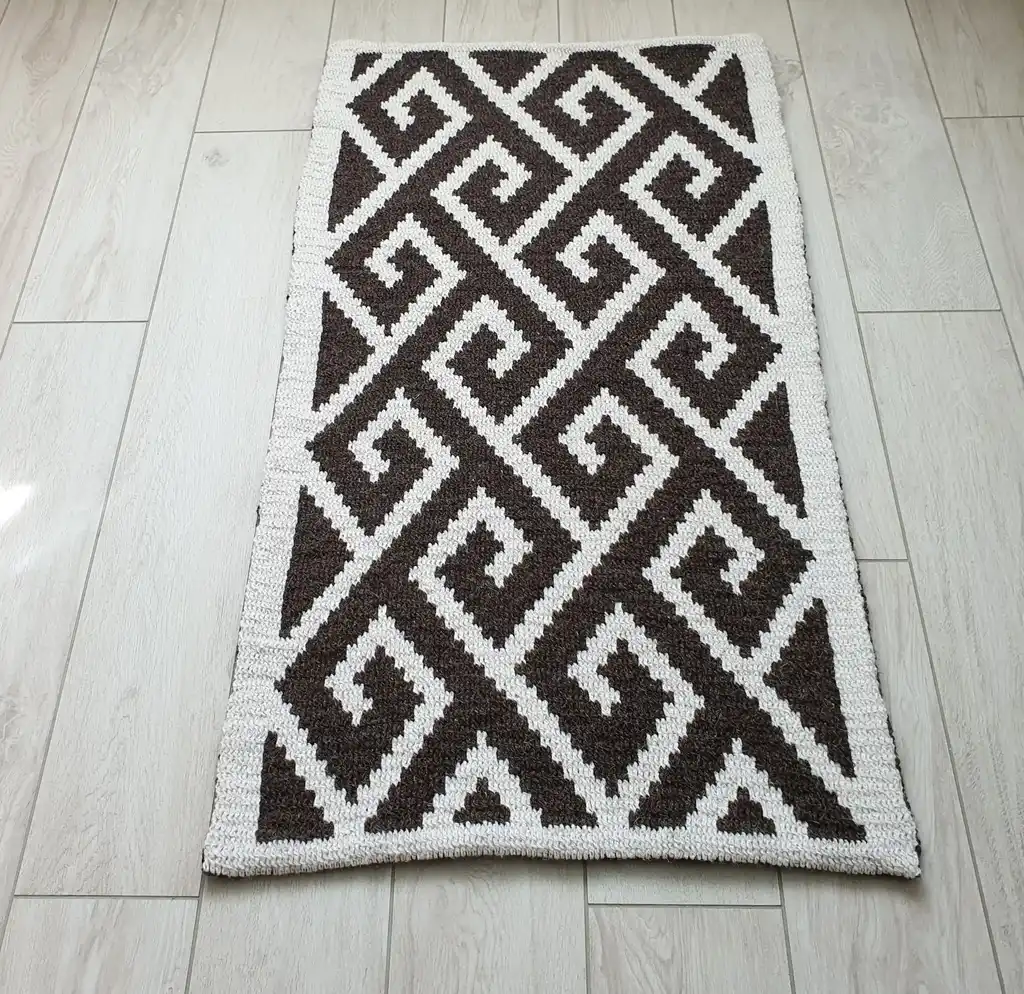 Crochet wool rug in natural colors, showing detailed texture and craftsmanship.