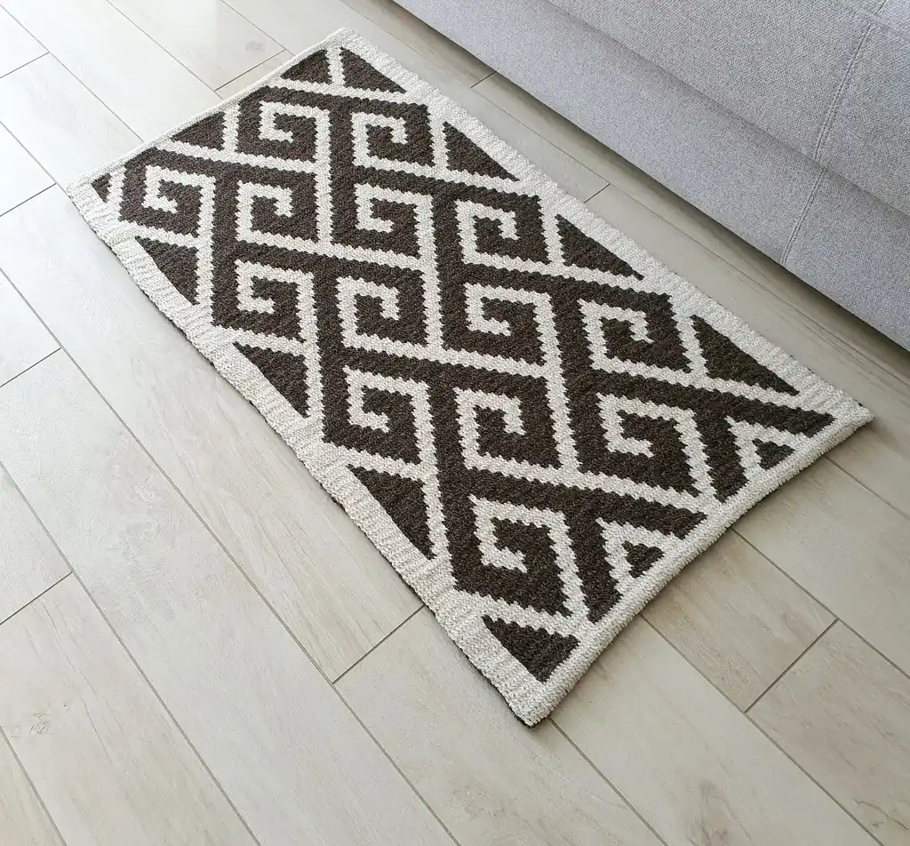 Crochet wool rug in natural colors, showing detailed texture and craftsmanship.