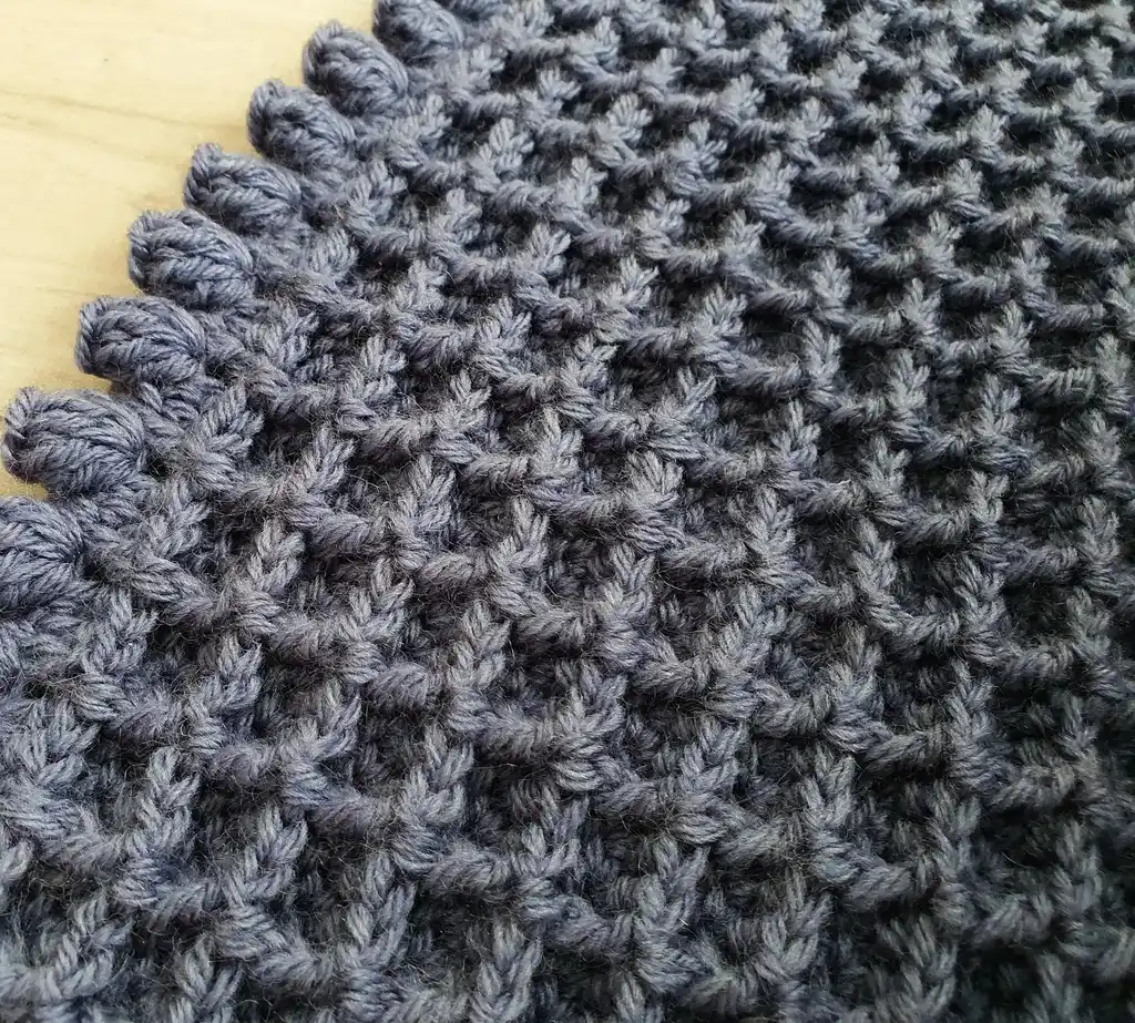 Crochet wool throw blanket in natural colors, machine washable.