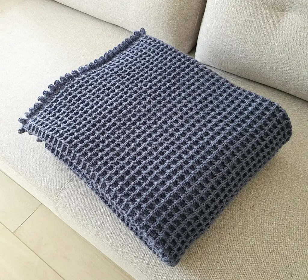 Crochet wool throw blanket in natural colors, machine washable.