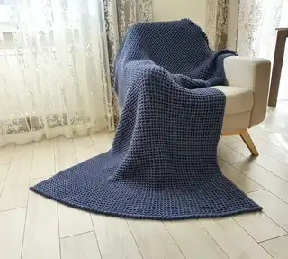 Crochet wool throw blanket in natural colors, machine washable.