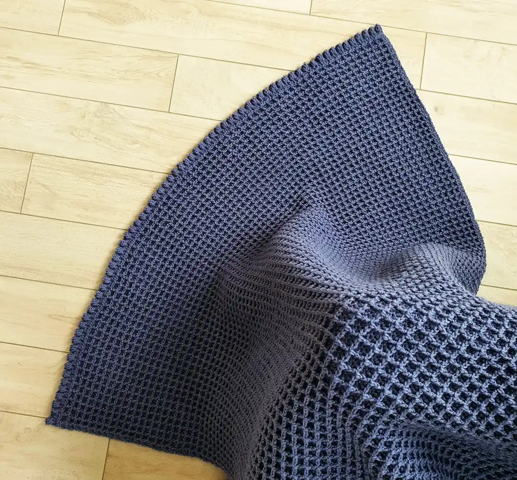 Crochet wool throw blanket in natural colors, machine washable.