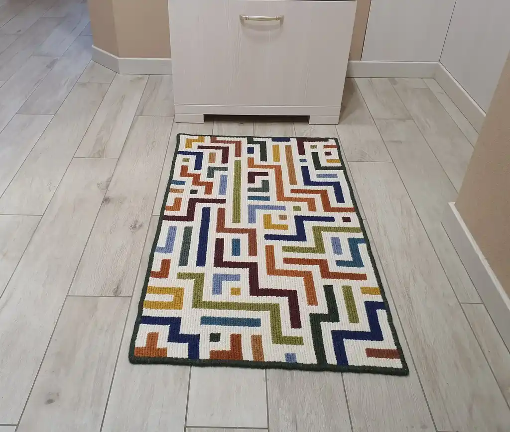 handcrafted embroidered wool rug with intricate traditional patterns.