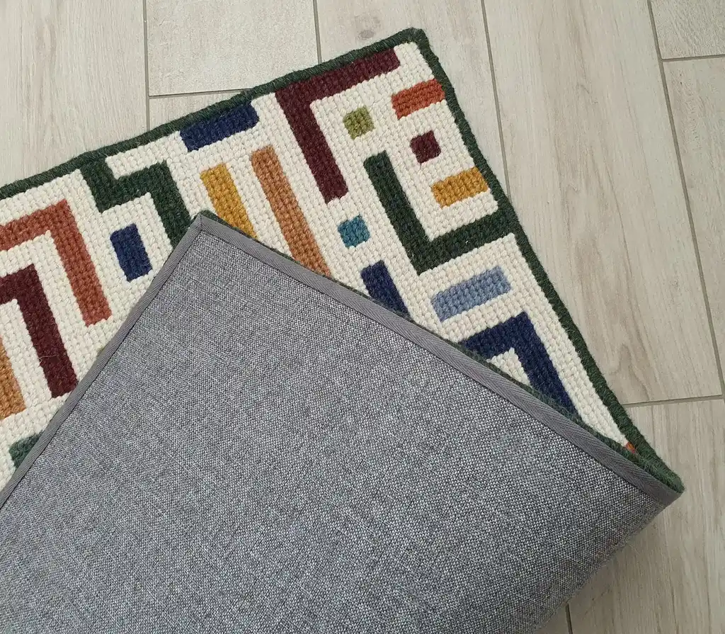 handcrafted embroidered wool rug with intricate traditional patterns.