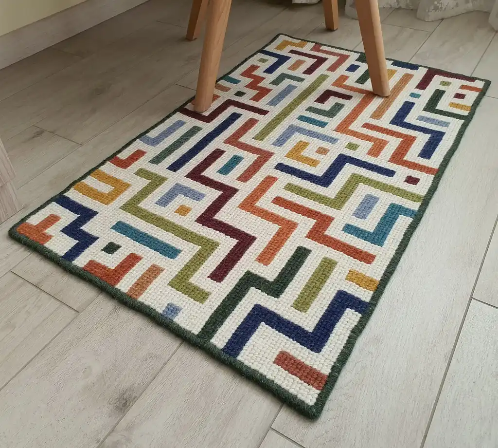 handcrafted embroidered wool rug with intricate traditional patterns.