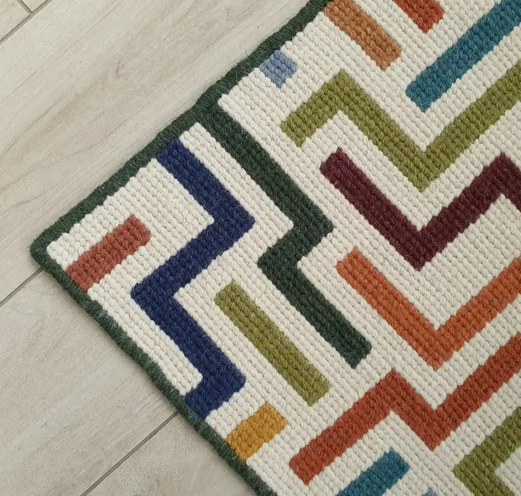 handcrafted embroidered wool rug with intricate traditional patterns.
