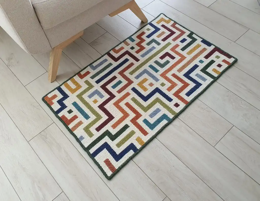 handcrafted embroidered wool rug with intricate traditional patterns.
