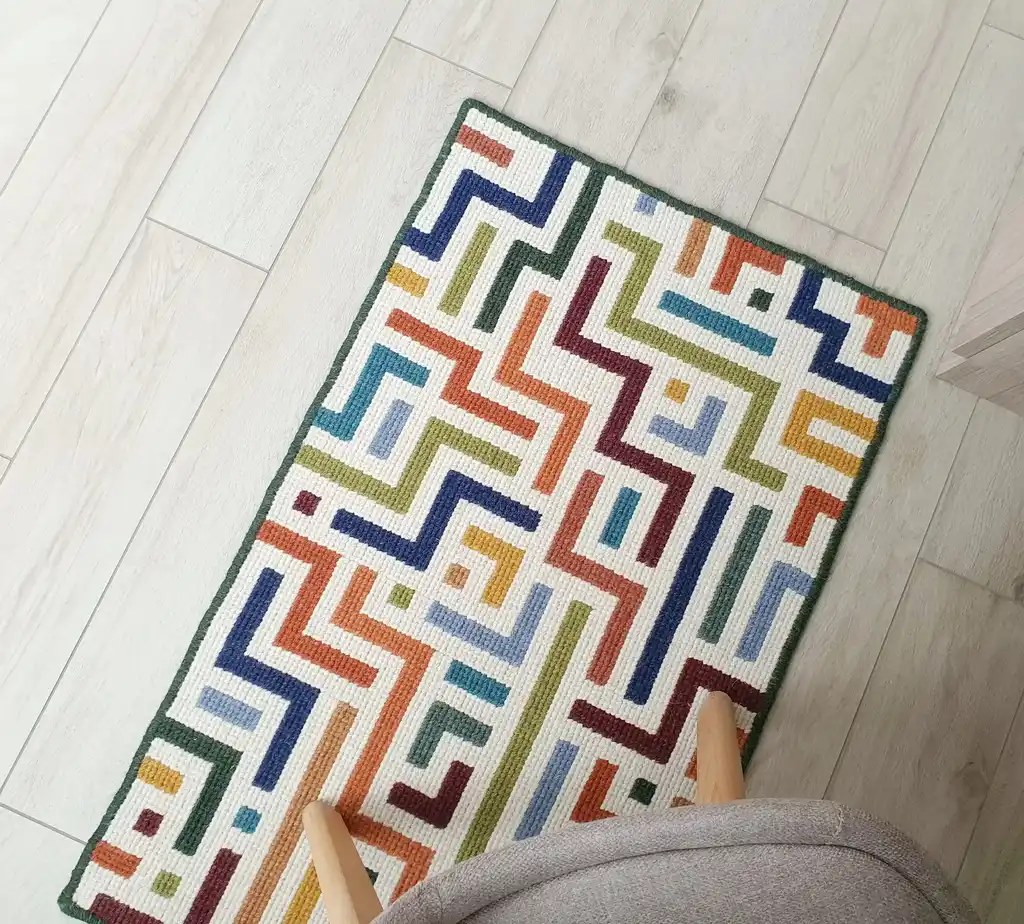 handcrafted embroidered wool rug with intricate traditional patterns.