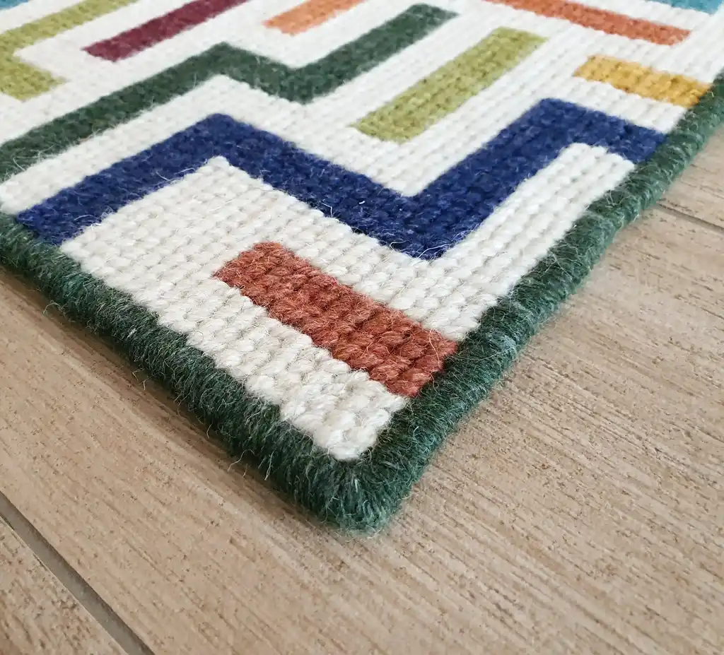 handcrafted embroidered wool rug with intricate traditional patterns.