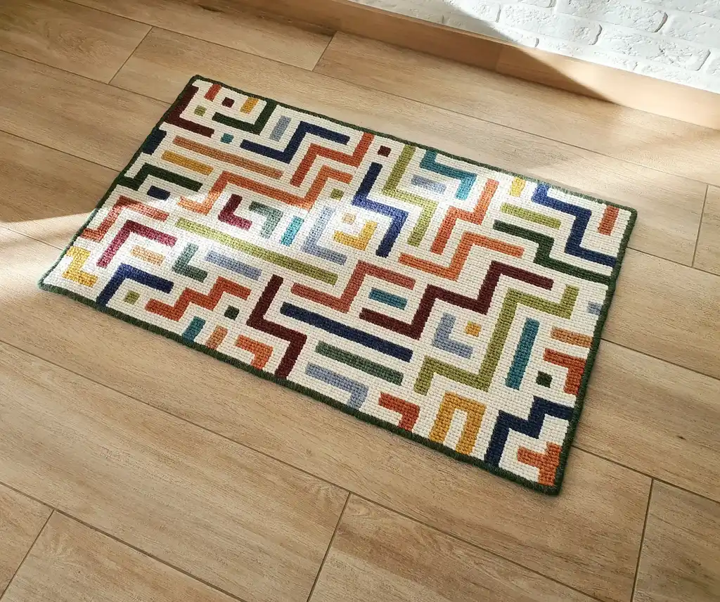 handcrafted embroidered wool rug with intricate traditional patterns.