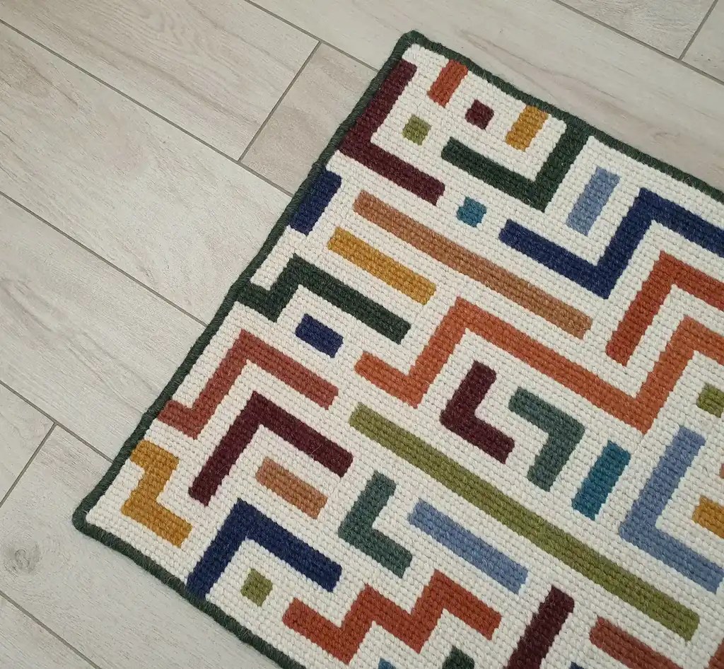 handcrafted embroidered wool rug with intricate traditional patterns.