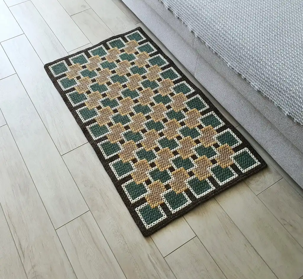 handmade cross-stitch rug made from wool and artificial felt, decorative floor covering.