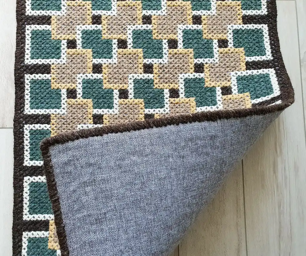 handmade cross-stitch rug made from wool and artificial felt, decorative floor covering.