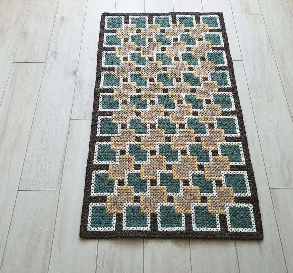 handmade cross-stitch rug made from wool and artificial felt, decorative floor covering.