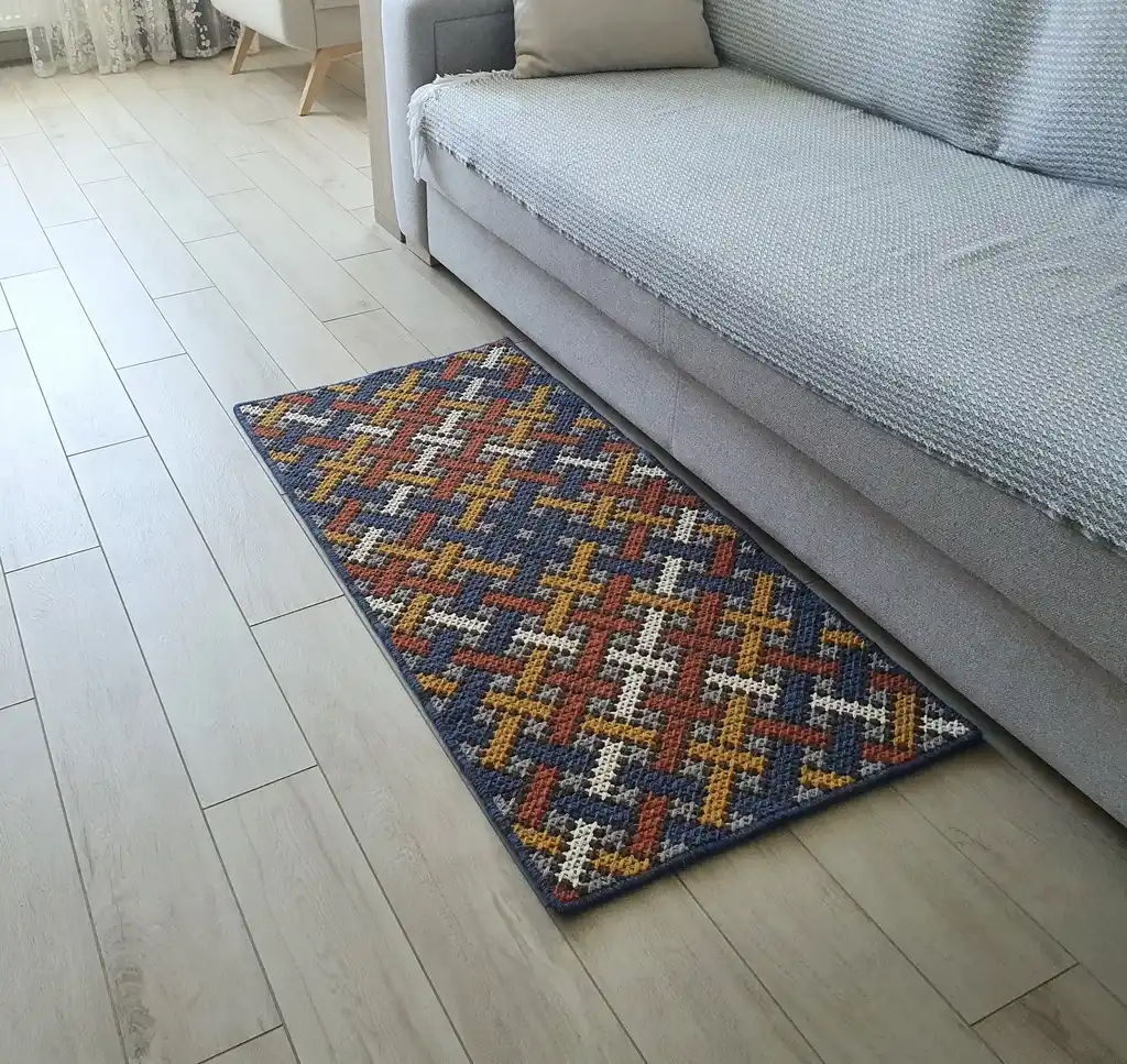 Handcrafted cross-stitch rug made from wool and felt, showcasing intricate embroidery patterns.