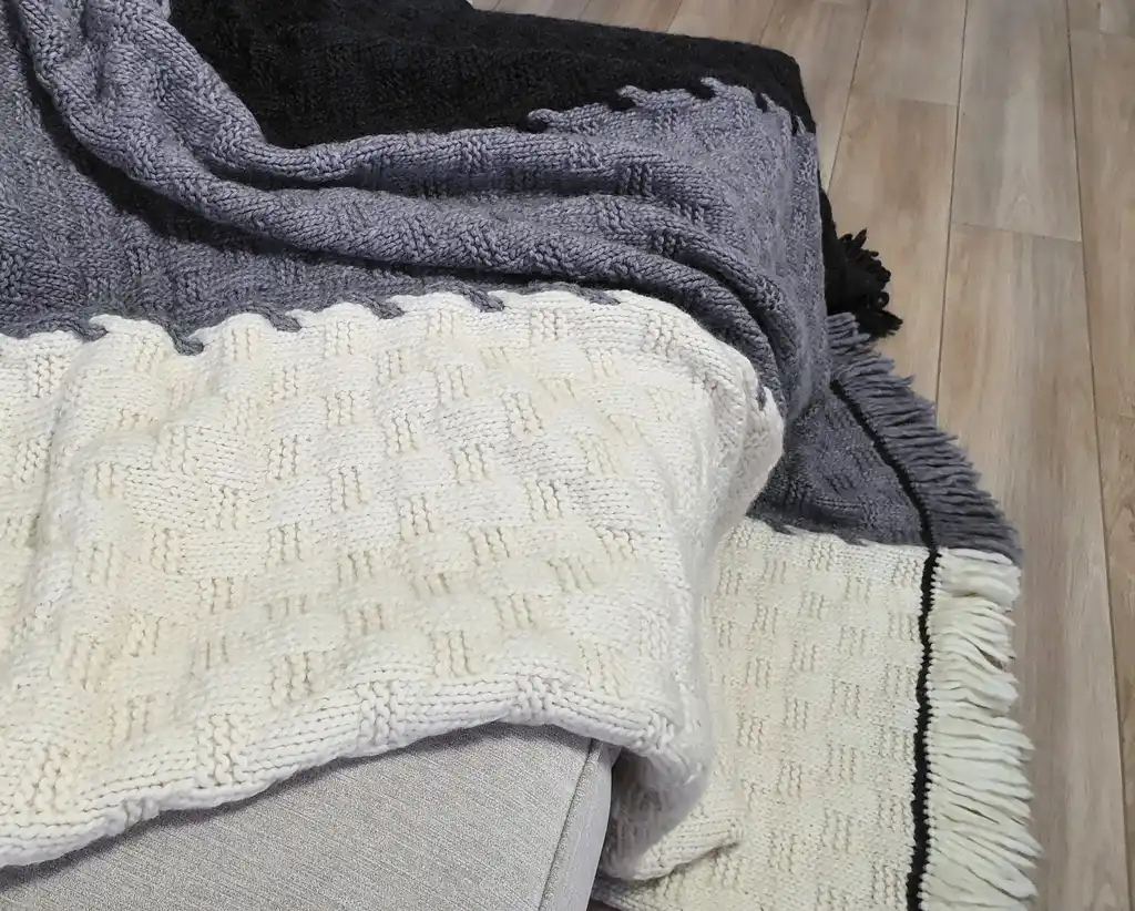 luxury merino wool knitted throw blanket in natural color, showing soft texture and quality craftsmanship.