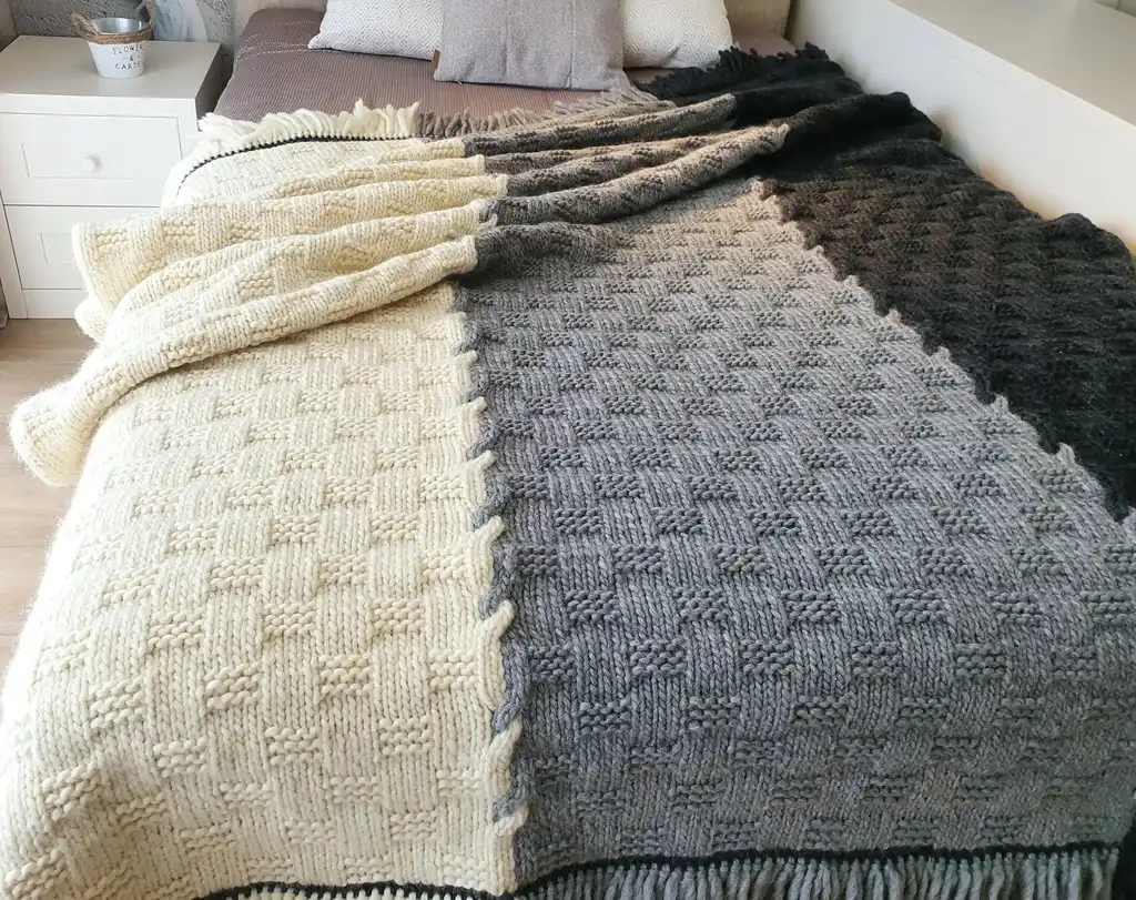 luxury merino wool knitted throw blanket in natural color, showing soft texture and quality craftsmanship.