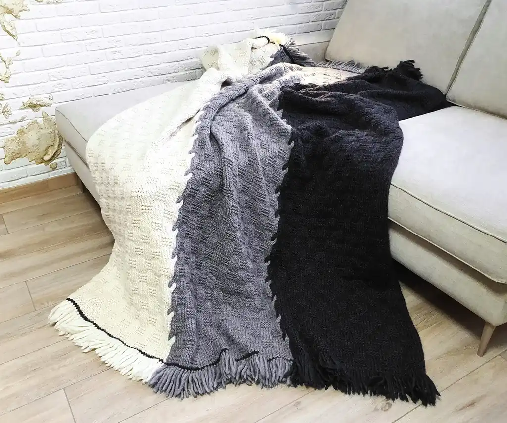 luxury merino wool knitted throw blanket in natural color, showing soft texture and quality craftsmanship.