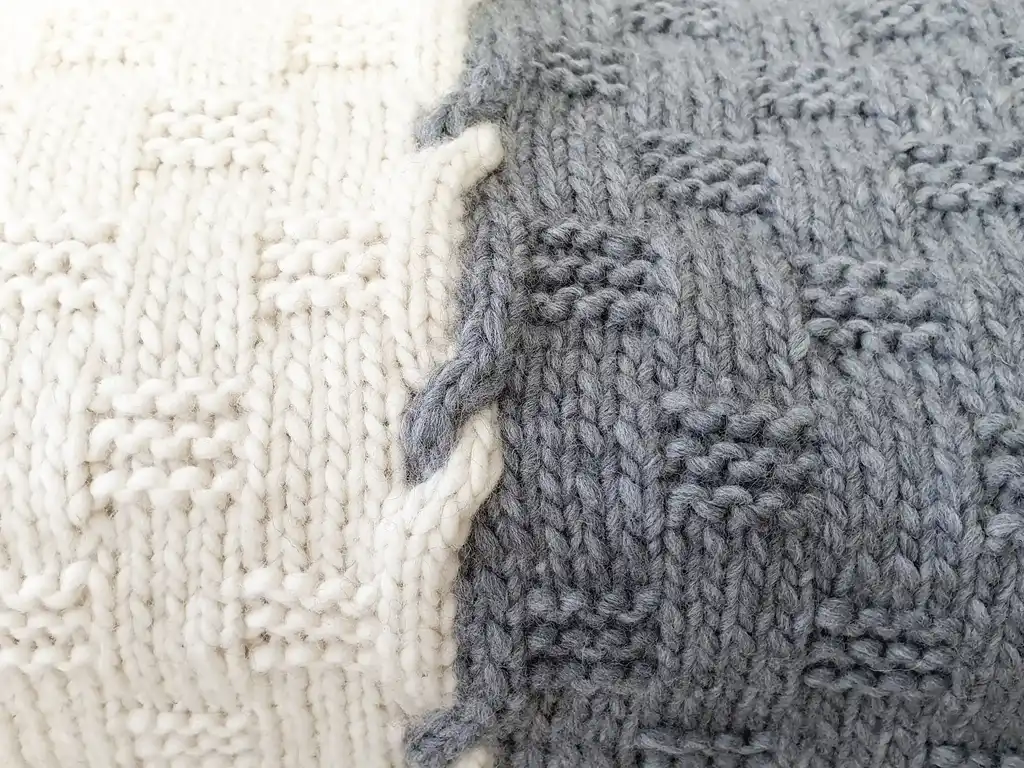luxury merino wool knitted throw blanket in natural color, showing soft texture and quality craftsmanship.