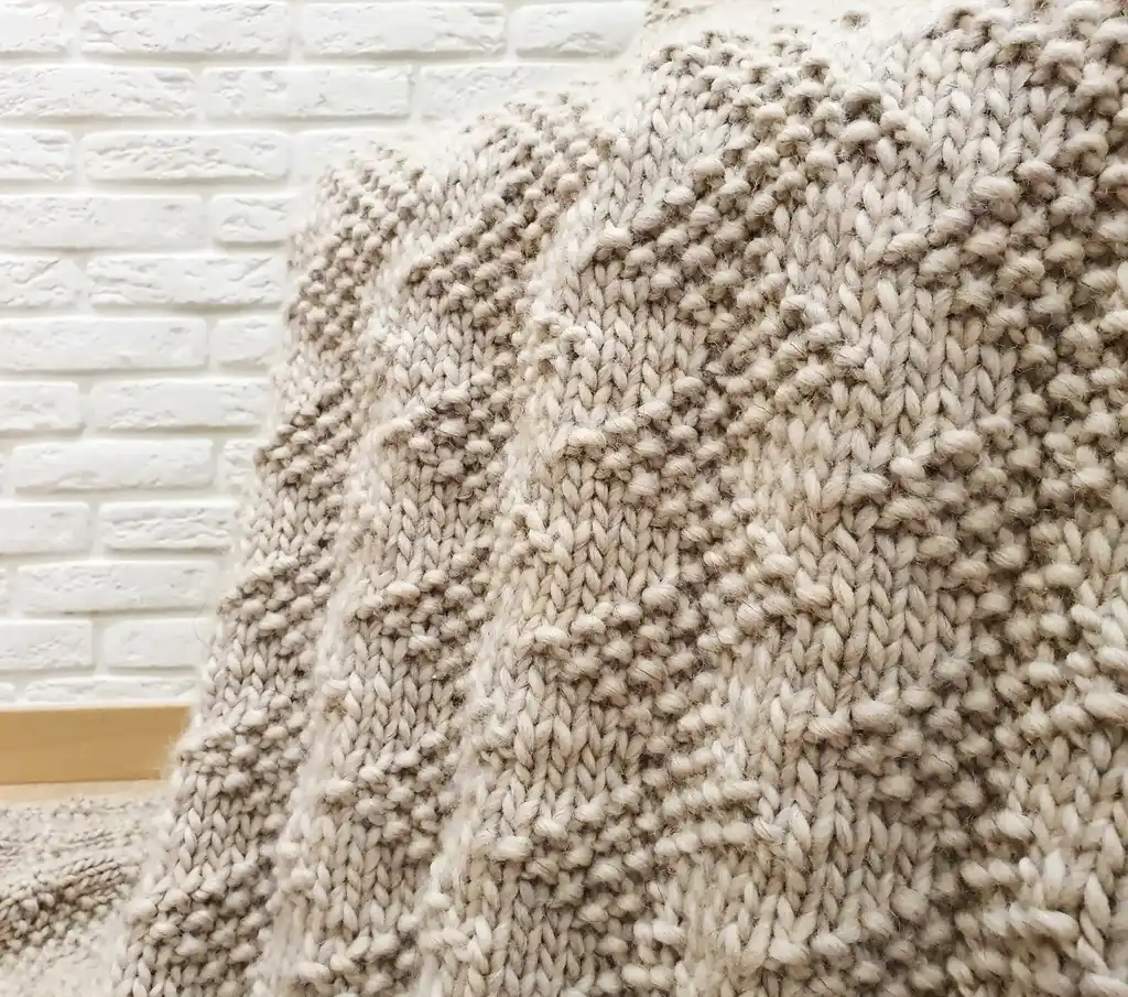 luxury merino wool knitted throw blanket for home decor.