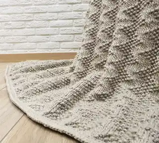 luxury merino wool knitted throw blanket for home decor.