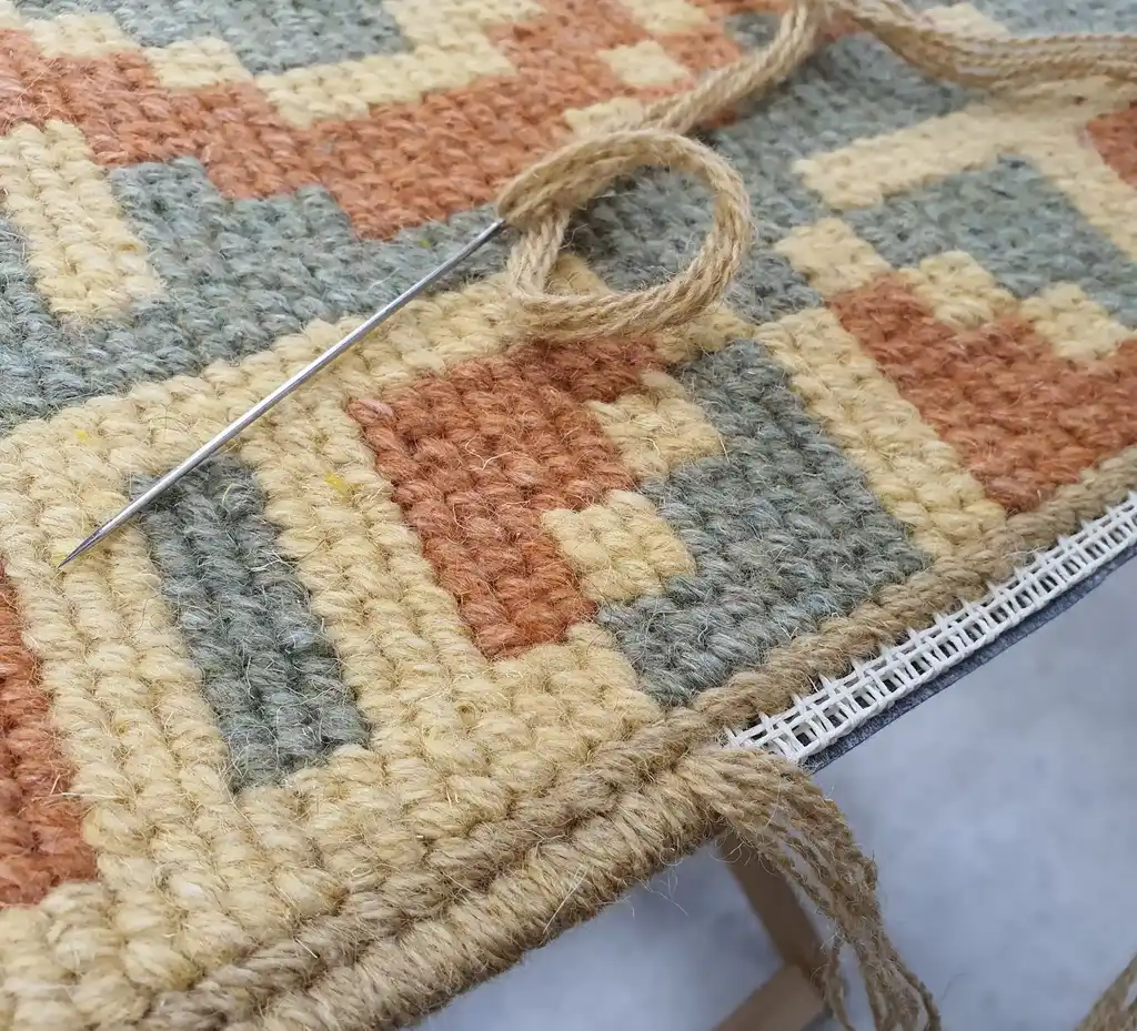 handcrafted wool rug with traditional embroidery pattern.