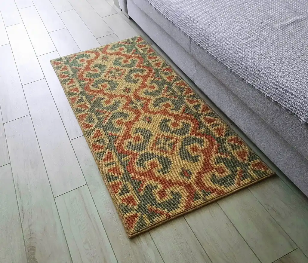 handcrafted wool rug with traditional embroidery pattern.