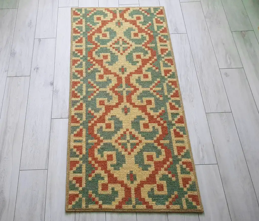 handcrafted wool rug with traditional embroidery pattern.