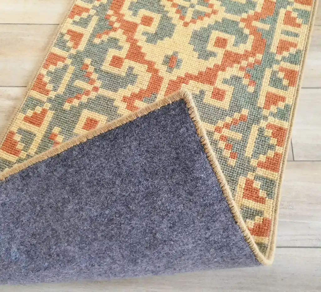 handcrafted wool rug with traditional embroidery pattern.